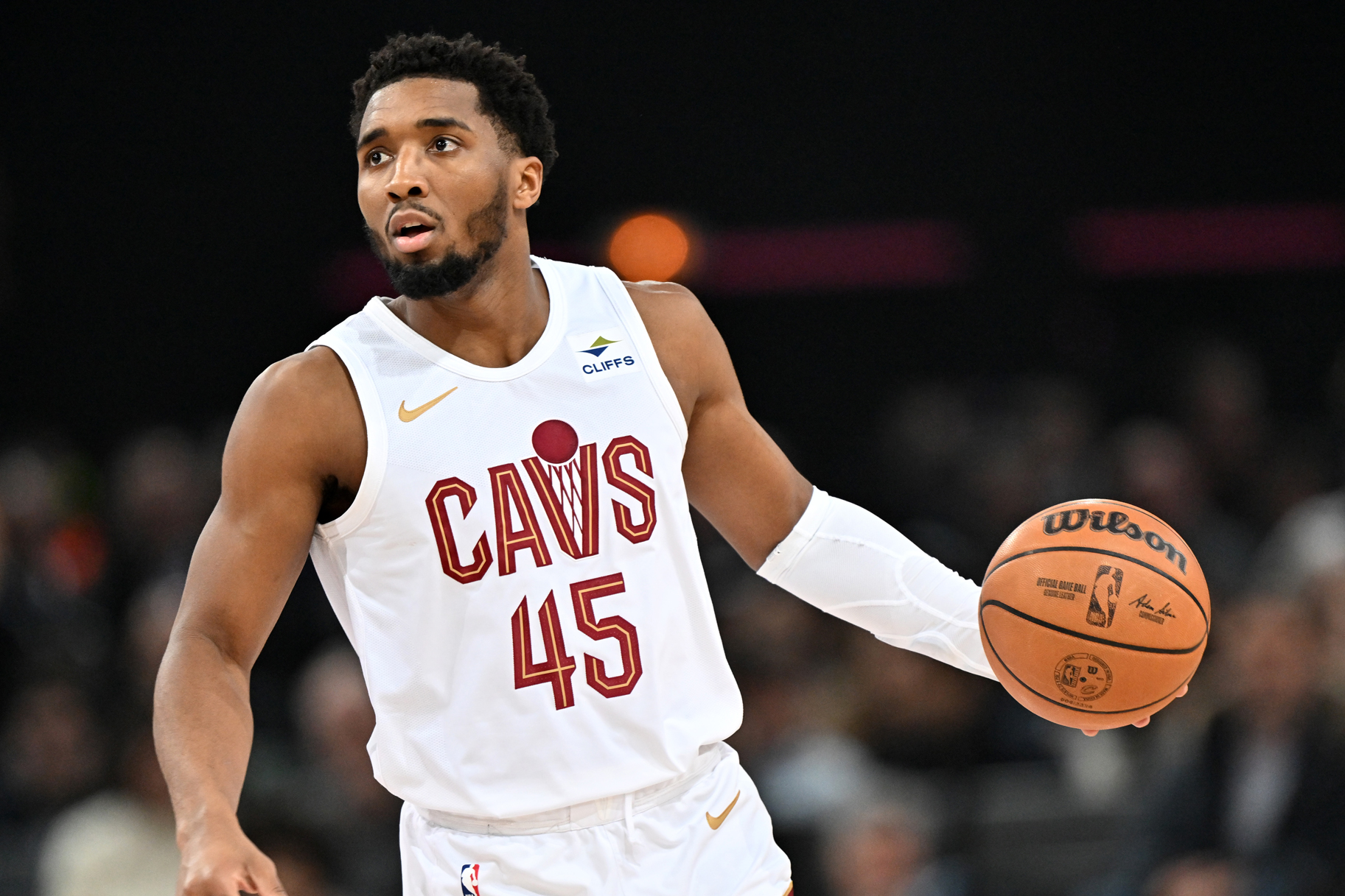Donovan Mitchell of Cleveland Cavaliers dribbling a basketball on a basketball court