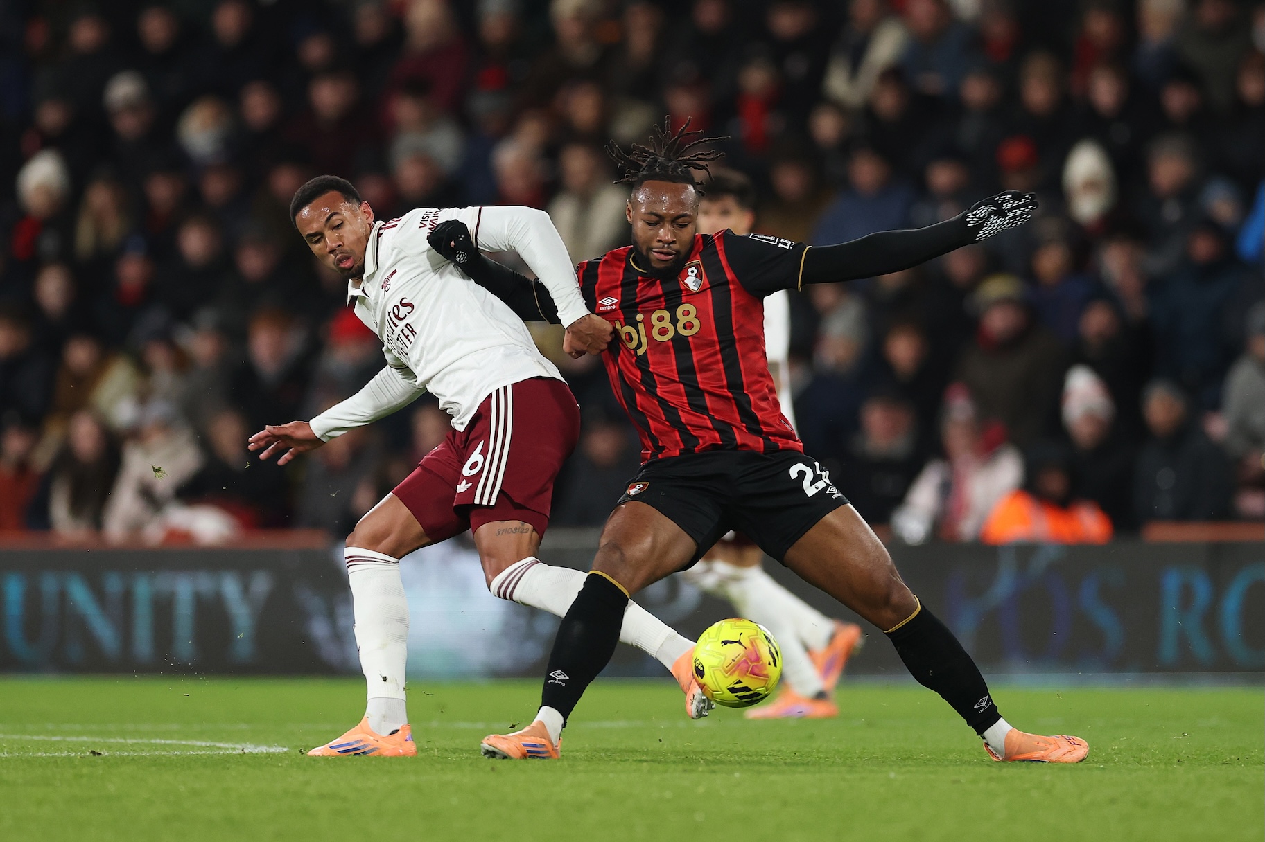 Antoine Semenyo of AFC Bournemouth is challenged by Gabriel Magalhães of Arsenal during a football match.