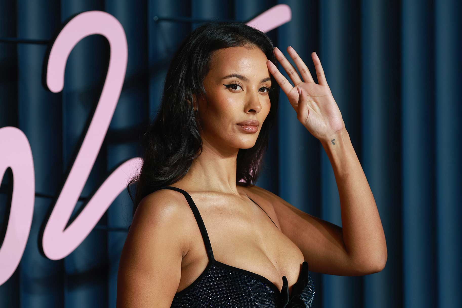 Maya Jama smiling and posing at The Fashion Awards 2025.