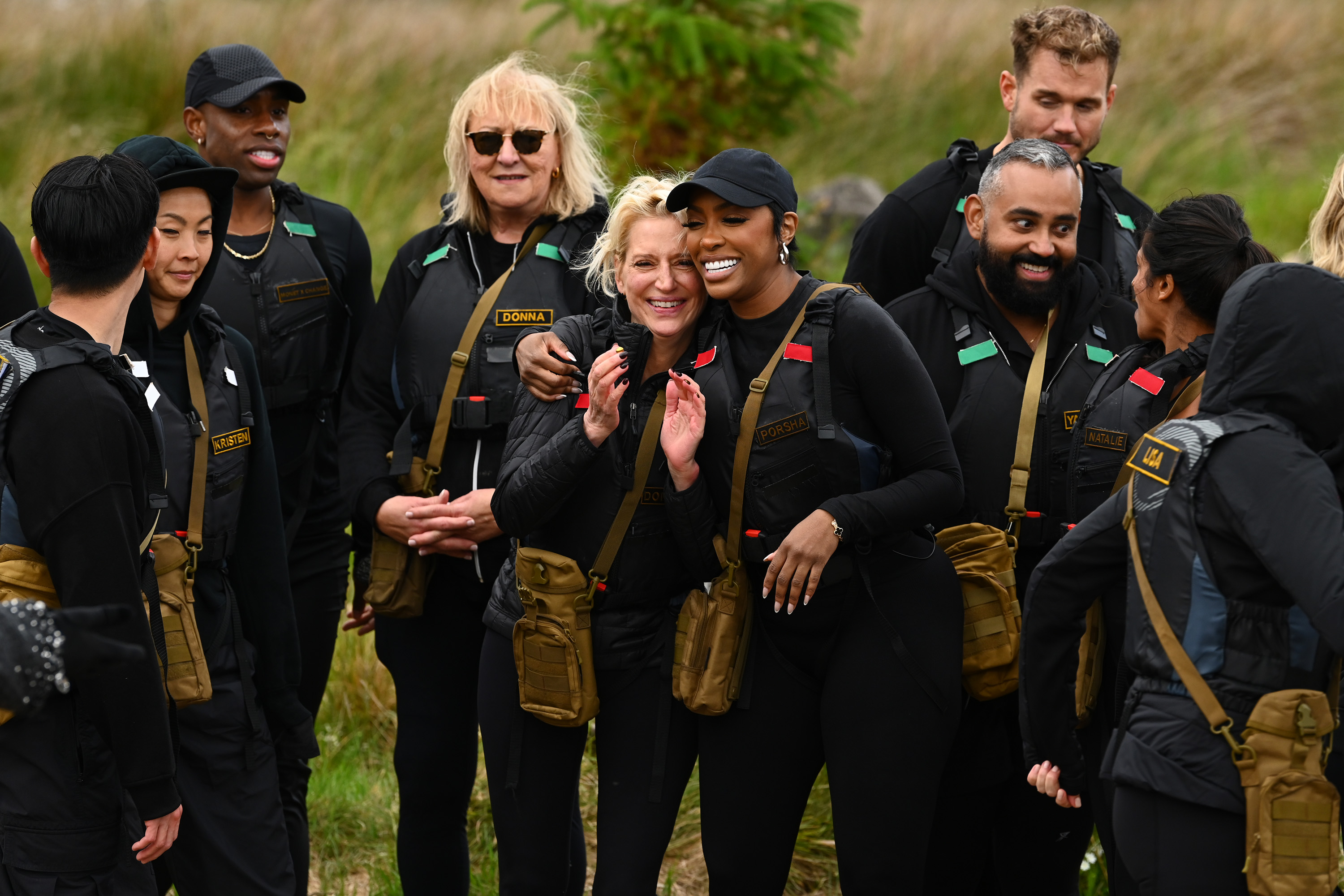 The Cast of The Traitors outside doing a challenge