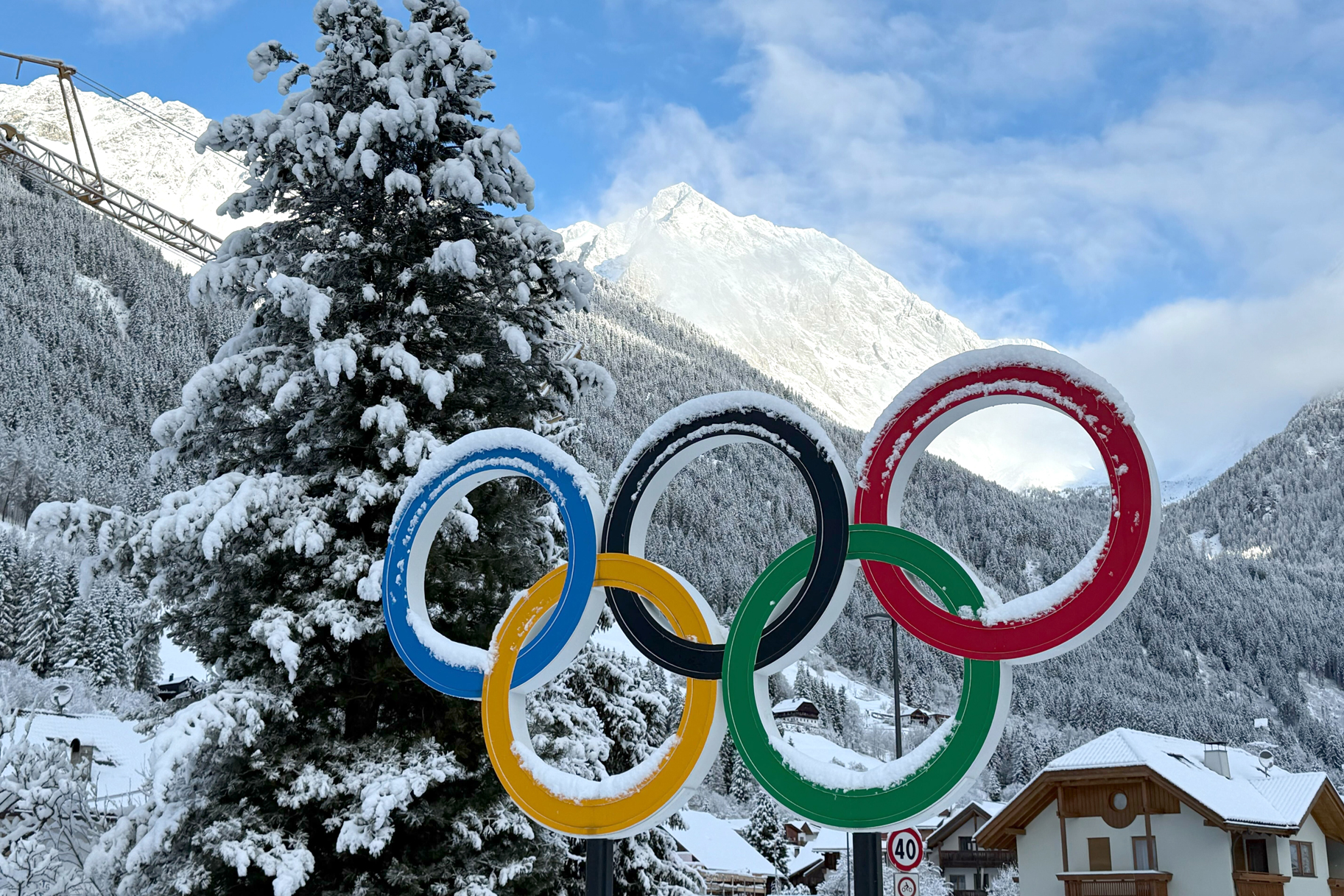 The Olympic rings stand in the snow on the roadside in the municipality of Antholz