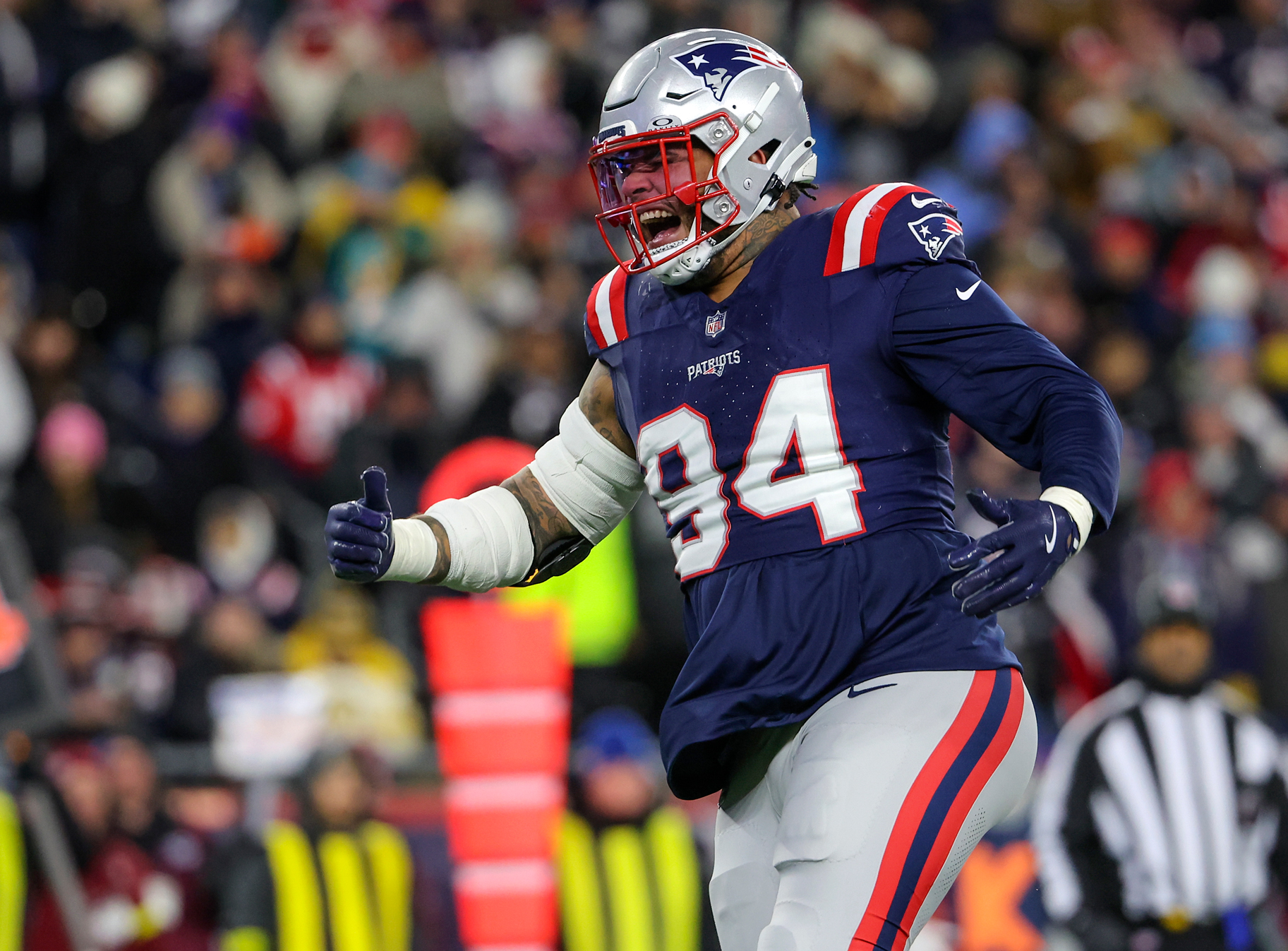New England Patriots defensive tackle Cory Durden celebrates a tackle in the second quarter on the field.