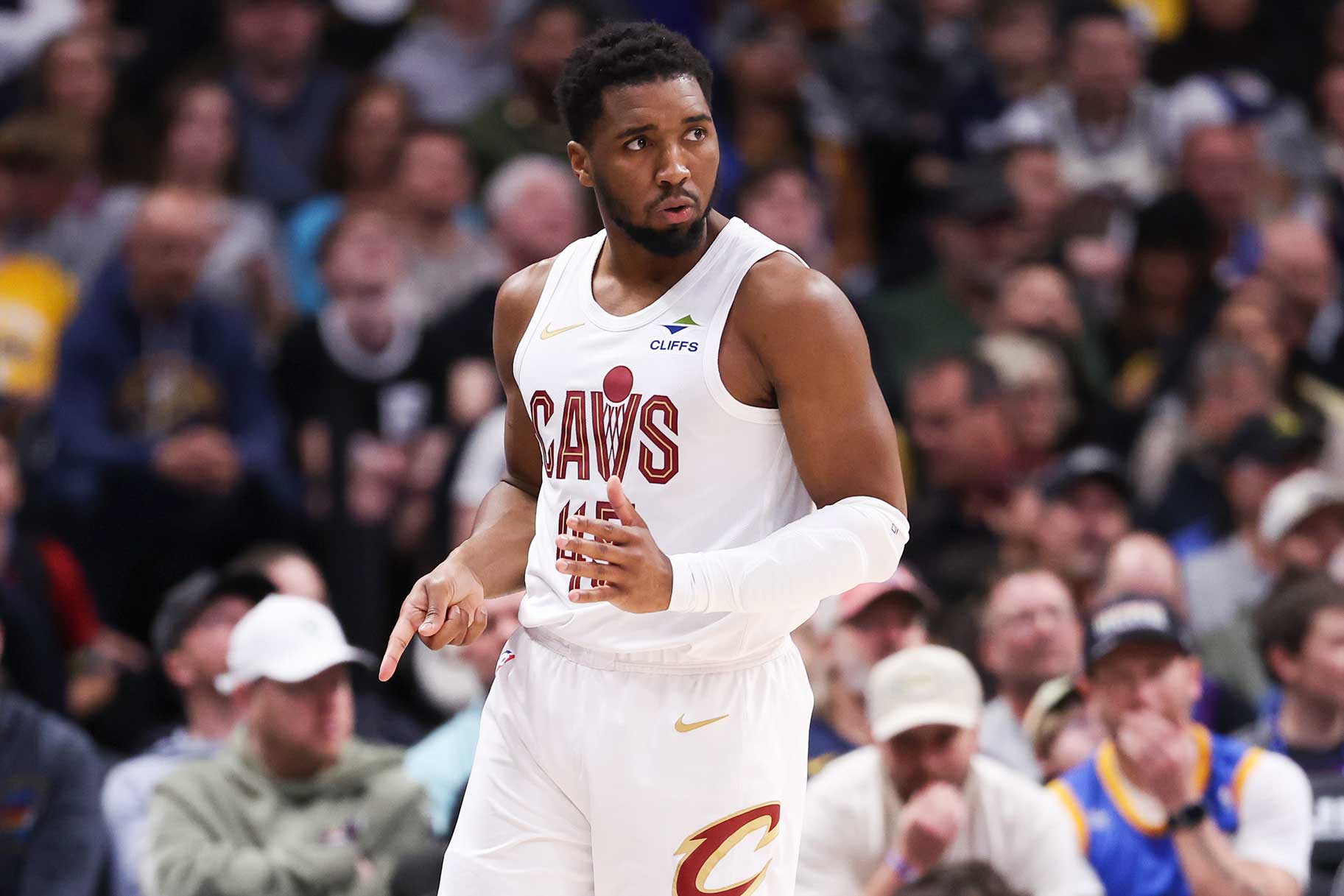 Donovan Mitchell of the Cleveland Cavaliers reacts after making a three point basket during the first quarter of the game against the Denver Nuggets.