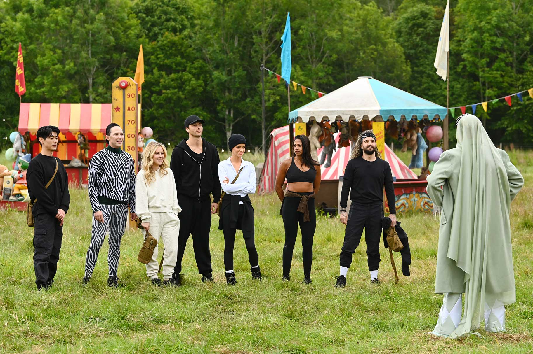 Eric Nam, Johnny Weir, Tara Lipinski, Rob Rausch, Maura Higgins, Natalie Anderson, and Mark Ballas outside together on The Traitors Season 4 Episode 10.