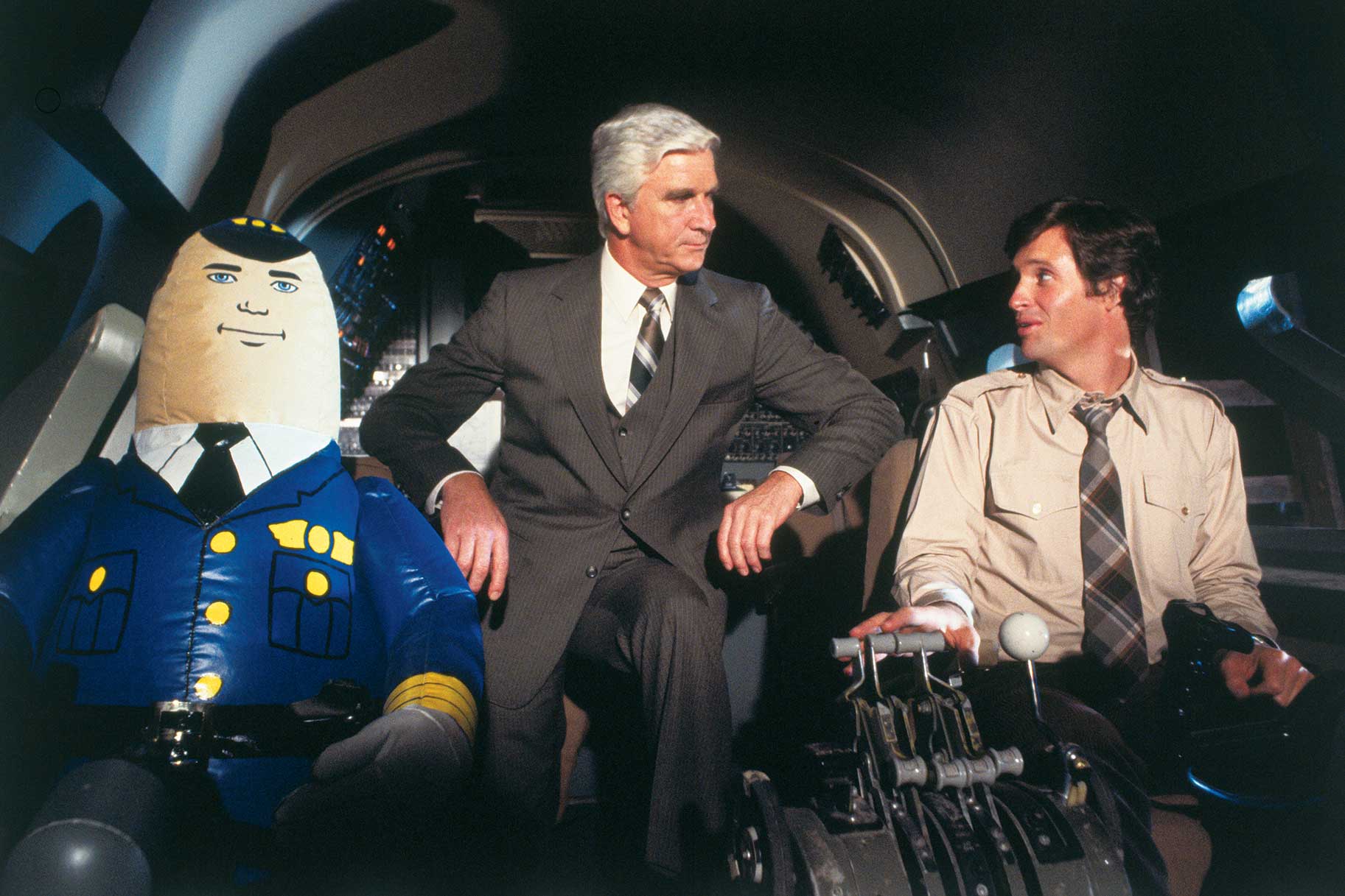 Dr. Rumack and Ted Striker sitting in the cockpit in Airplane! (1980).