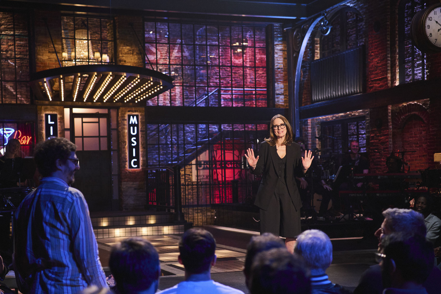 Tina Fey talks onstage in Saturday Night Live UK Season 1 Episode 1.