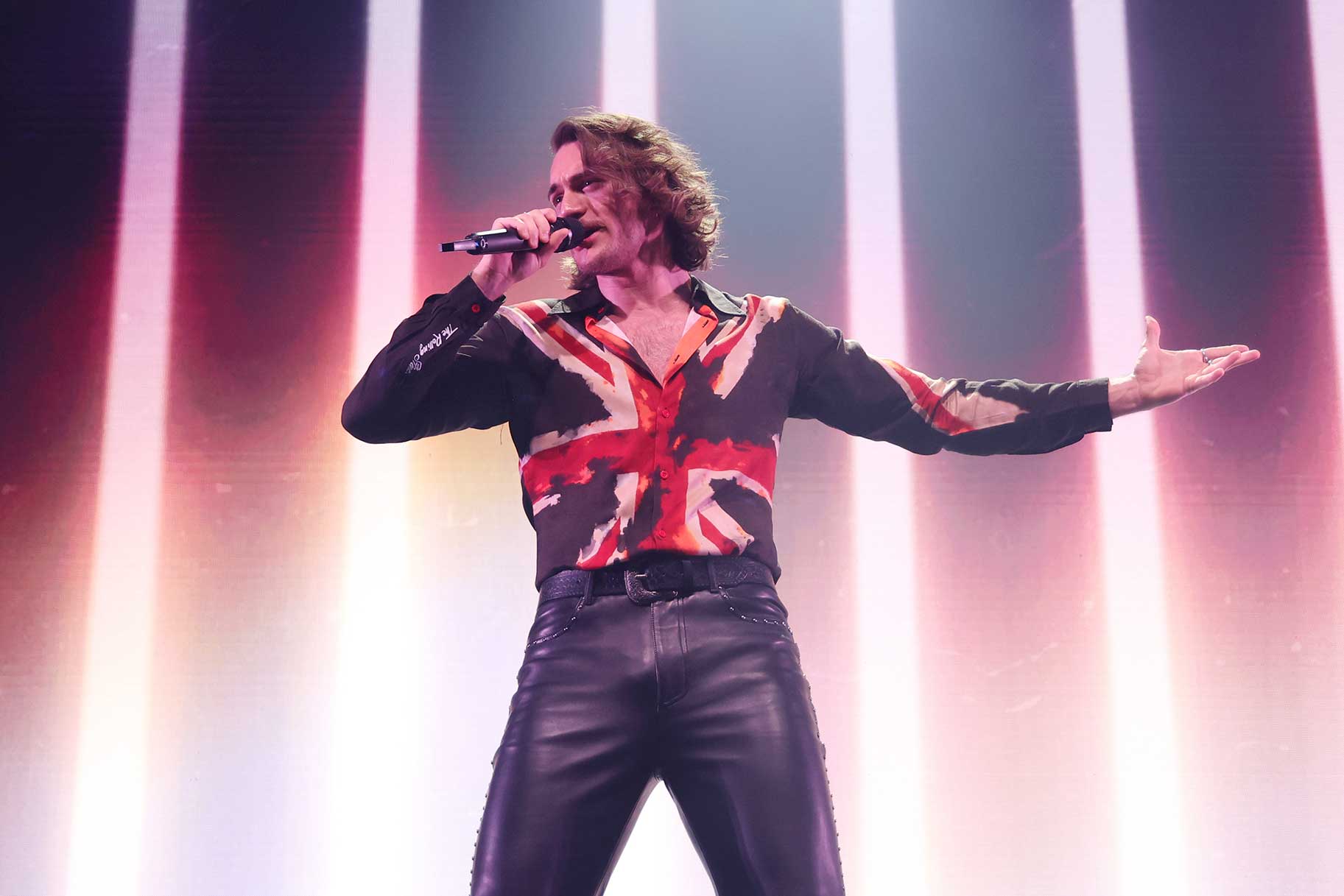 Aidan singing on stage during the London Eurovision Party 2026.