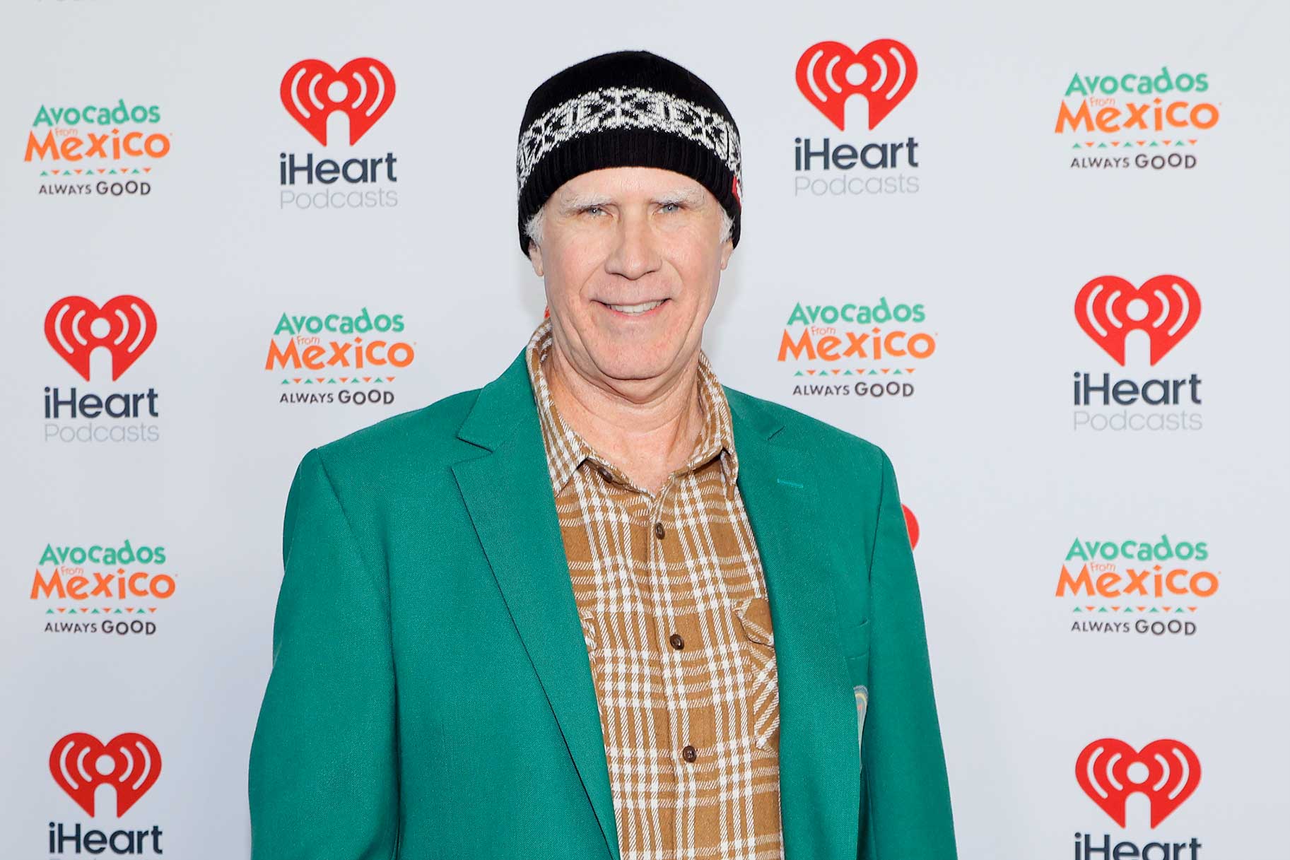 Will Ferrell in a green blazer and beanie at the 2026 iHeartPodcast Awards.