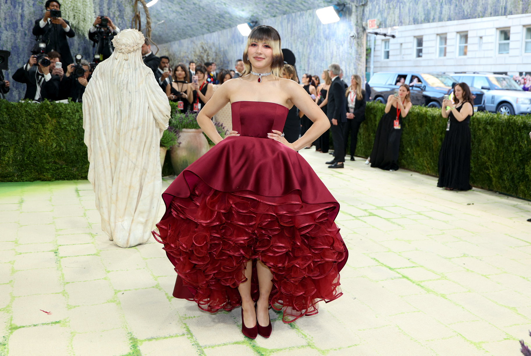 Alysa Liu Met Gala arriving at the 2026 Met Gala wearing a deep red gown.