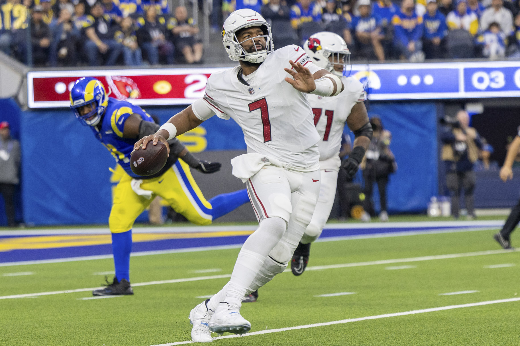 Jacoby Brissett, Arizona Cardinals Quarterback #7, preparing to throw a ball during a game.