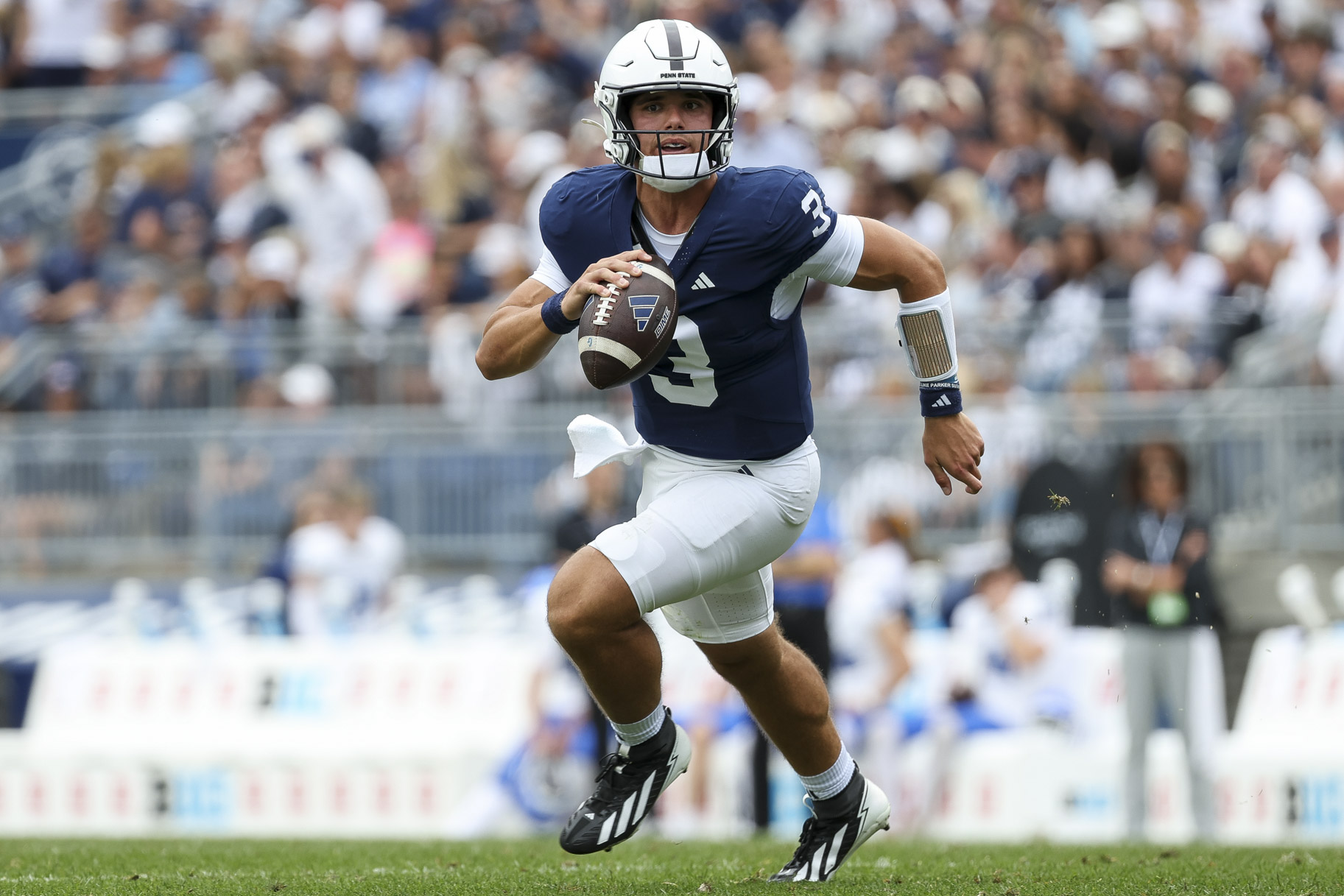 Rocco Becht, #3 of the Penn State Nittany Lions, running with the ball during a game.