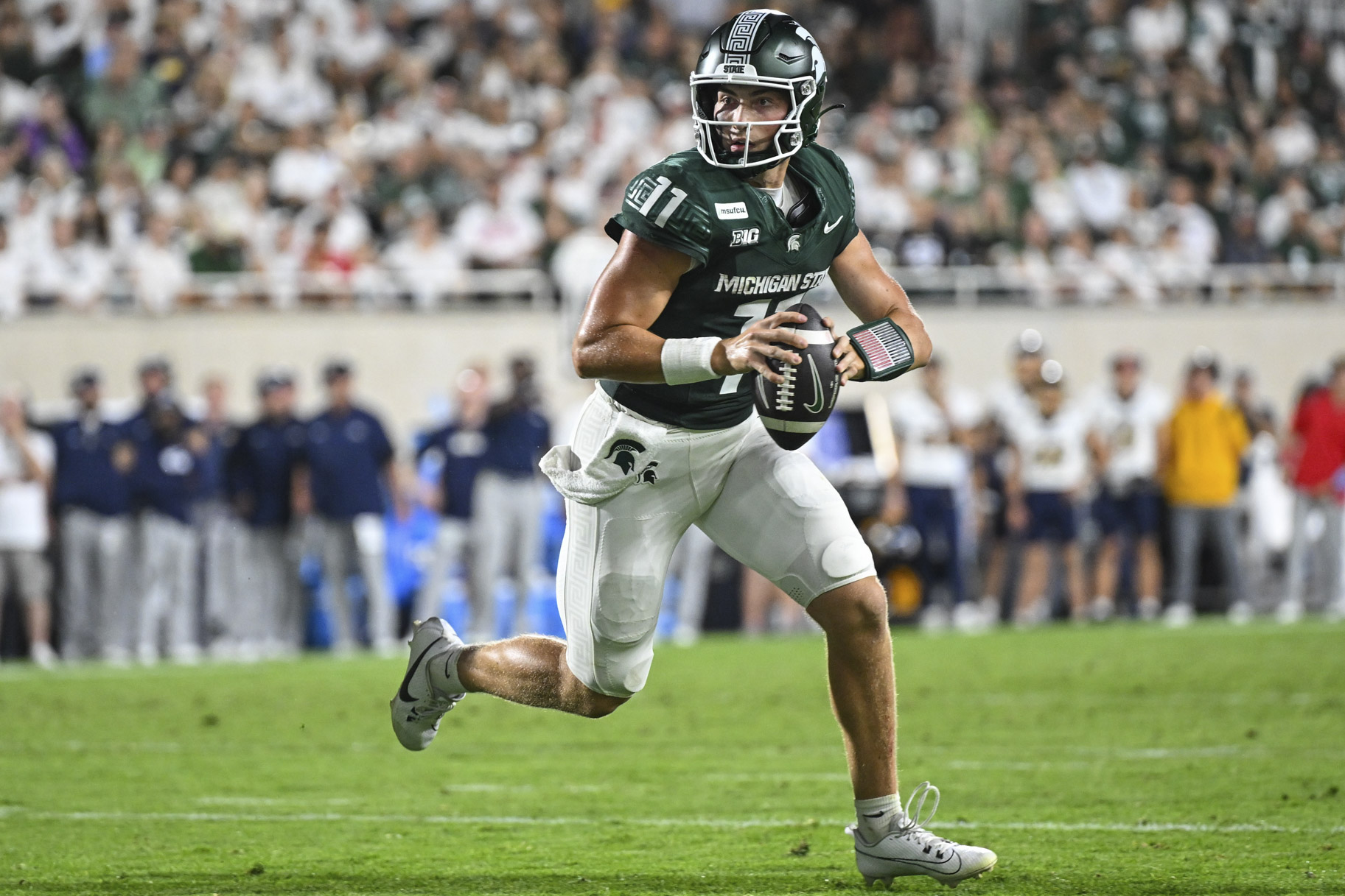 Quarterback Alessio Milivojevic, #11 of the Michigan State Spartans, running with the football during a game.