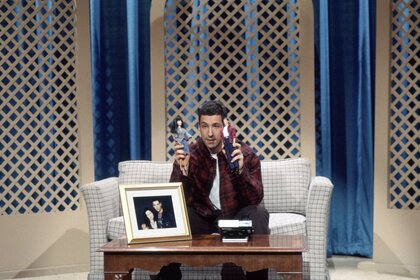 Brian (Adam Sandler) plays with dolls on SNL Episode 1915.