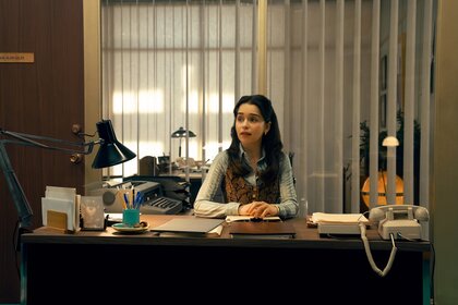 Bea (Emilia Clarke) works at a desk on Ponies Episode 103.