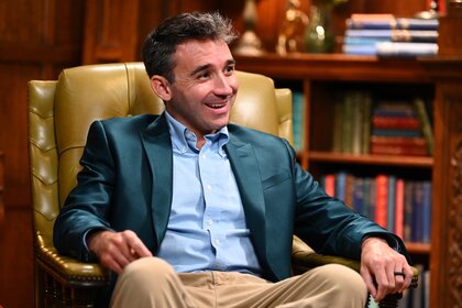 Porsha Williams sits in an armchair on The Traitors Episode 401.