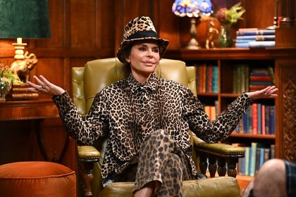 Lisa Rinna shrugs in a full cheetah print suit and fedora on The Traitors Episode 401.