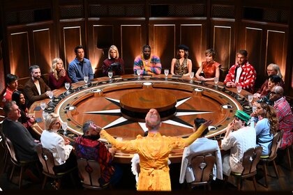 The cast of The Traitors gather around a giant round table on Episode 403.