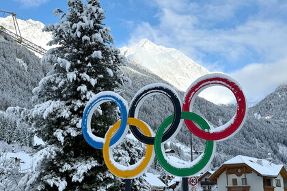 The Olympic rings stand in the snow on the roadside in the municipality of Antholz