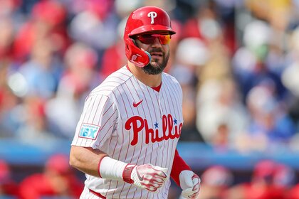 Kyle Schwarber of the Philadelphia Phillies runs to first base after being hit by a pitch from the Pittsburgh Pirates.