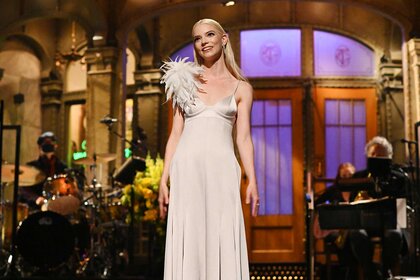 Anya Taylor-Joy dressed in a champaign dress during her monologue on Saturday Night Live Season 46 Episode 20.