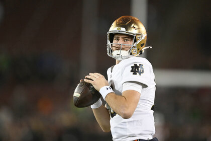 CJ Carr of the Notre Dame Fighting Irish warms up before the game against the Stanford Cardinal.
