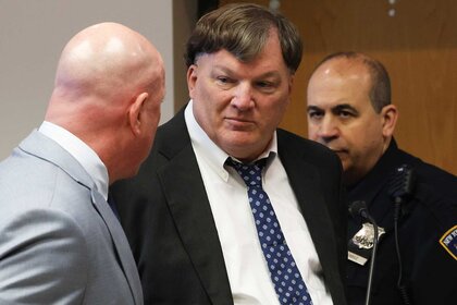 Killer Rex A. Heuermann walking with two men.