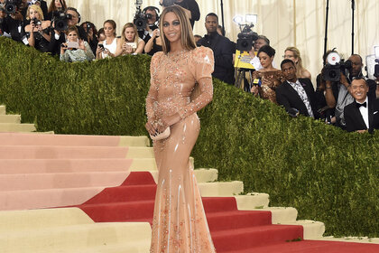 Beyonce Knowles Carter posing in a latex gown on the Met Gala red carpet.