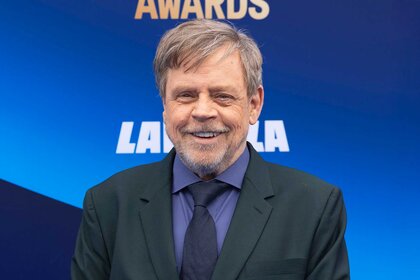 Mark Hamill smiling in a gray suit at the 2026 Film Independent Spirit Awards.