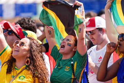 South African fans cheering while holding flags during the World Cup 2026 Fan Festival.