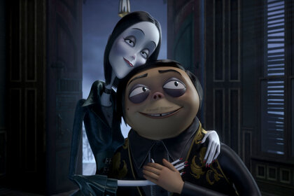 Gomez and Morticia Adams embracing in front of an open window during The Addams Family (2019).