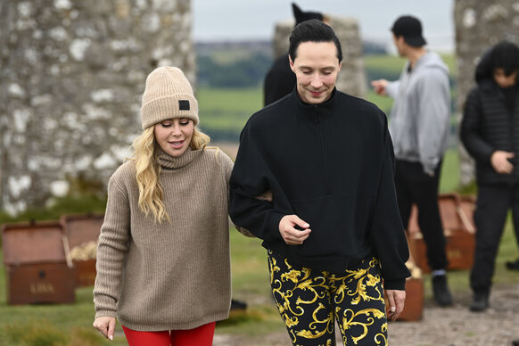 Tara Lipinski and Johnny Weir walk and talk together during The Traitors Season 4 Episode 7.