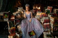 Glinda (Ariana Grande) sits on a giant pile of books and magazines in Wicked For Good (2025).