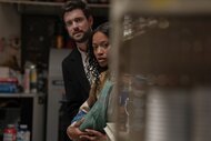 Rob (Jack Whitehall) and Samira (Keke Palmer) peer past a pantry shelf on The Burbs Episode 102.