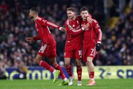 Florian Wirtz of Liverpool celebrates scoring his team's first goal with teammates Alexis Mac Allister and Cody Gakpo.
