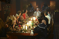 The cast sitting at a banquet table in The Traitors Season 4 Episode 7.