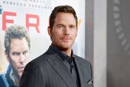 Chris Pratt smiling in a gray suit at the New York Premiere of Mercy.