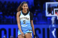 Angel Reese, #5 of the Chicago Sky, smiling on the court during a game.