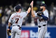 Kevin McGonigle and Riley Greene high-five after defeating the San Diego Padres.