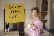 Lindy (Elizabeth Banks) holds a coffee mug in The Miniature Wife Season 1.