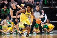 Takai Simpkins of the Oregon Ducks brings the ball up court during the first half against the Michigan State Spartans.