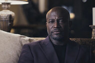 Taye Diggs sits on a sofa in Another Man's Wife (2026).