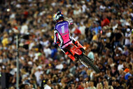 Jett Lawrence jumps in front of fans in the grandstands during the 450 Moto 1 race during the SuperMotocross World Championship Final.