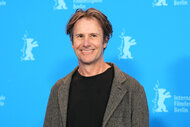 Josh Hamilton stands in front of the blue wall during the photocall for the film "Reality".