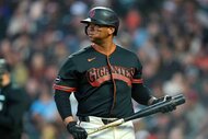 Rafael Devers of the San Francisco Giants reacts walking back to the dugout after striking out against the Pittsburgh Pirates.