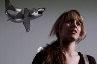 A shark flying in the air while Claudia looks on in Sharknado (2013).