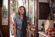 Anna (Halle Bailey) walking into a shop in You, Me & Tuscany (2026).
