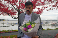 Felipe Cruz holding a bouquet of flowers at a park.