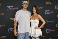 Maura Higgins and Rob Rausch posing together in front of a step and repeat.