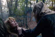 Linda Cardellini as Pam Voorhees leans against a tree in a forest while Zachary Branch as Adult Jason Voorhees grabs Pam Voorhees by the neck with a sack covering the face.