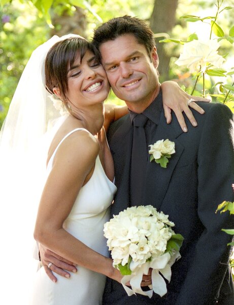 Lisa Rinna and Harry Hamlin smile in their wedding outfits.